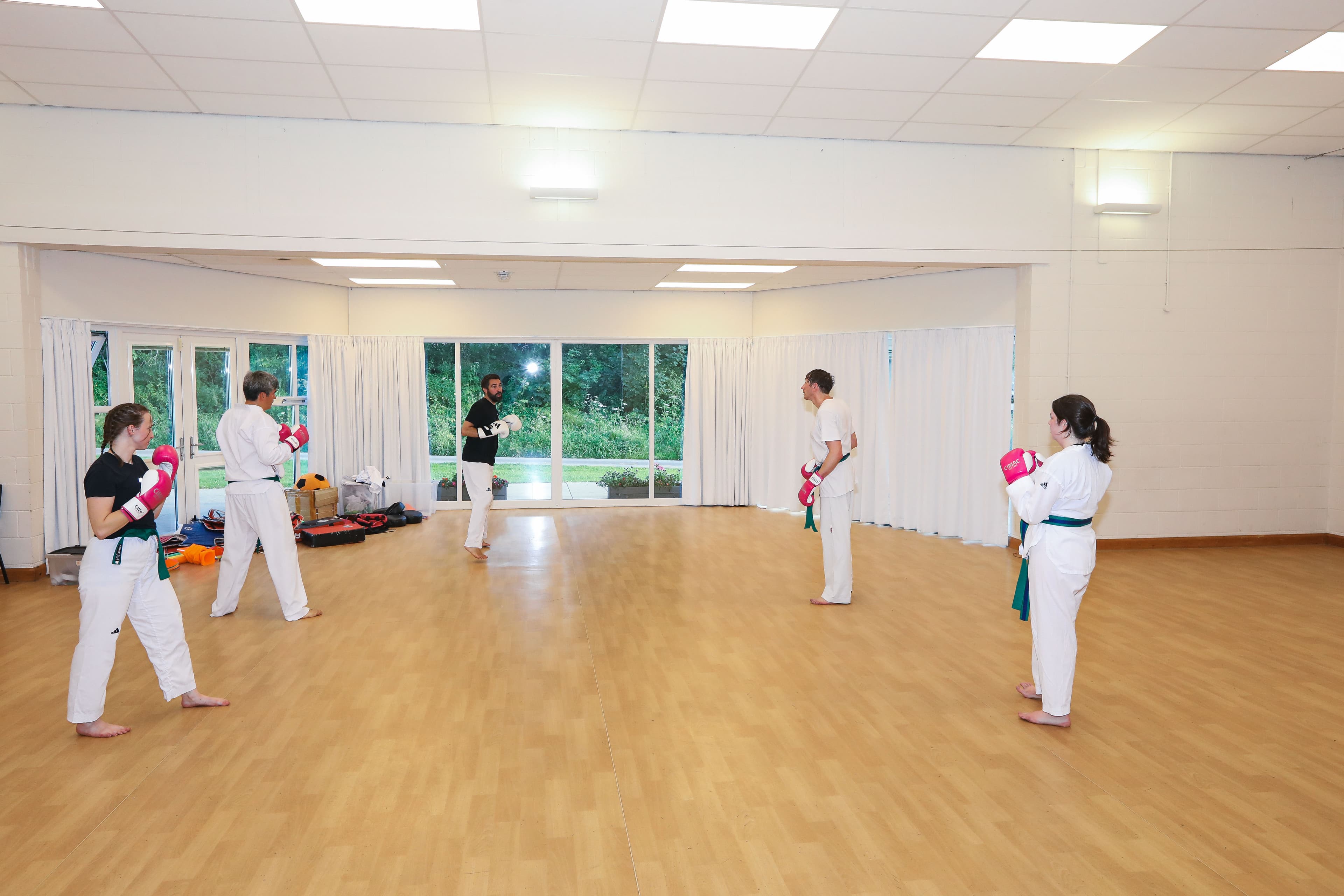 Adults in a Taekwondo class at Vortex Martial Arts Academy in Lancaster, Andy demonstrating in the middle
