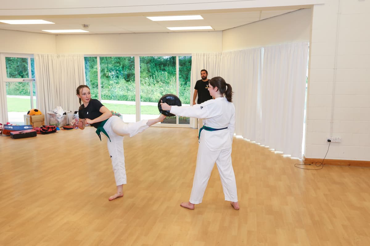 Instructor coaching adult students at Vortex Martial Arts