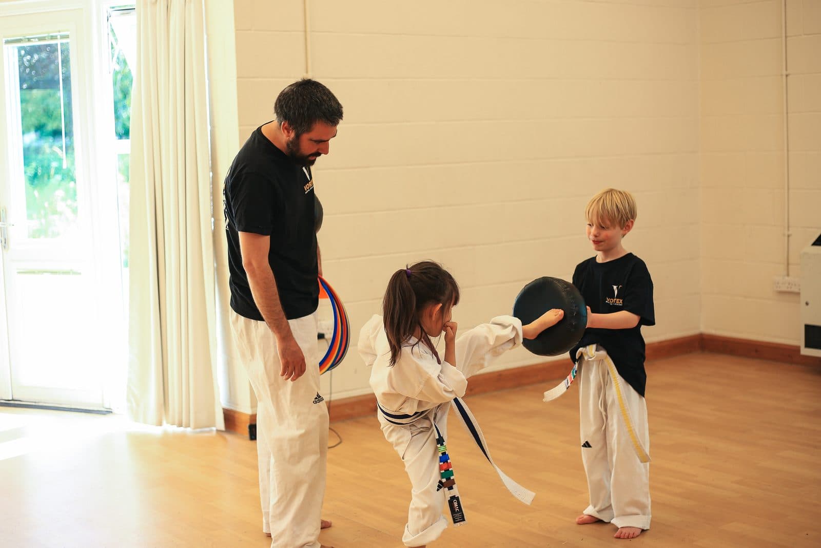 Young children aged 4 to 7 enjoying a Dragons martial arts class at Vortex Martial Arts Academy, Lancaster