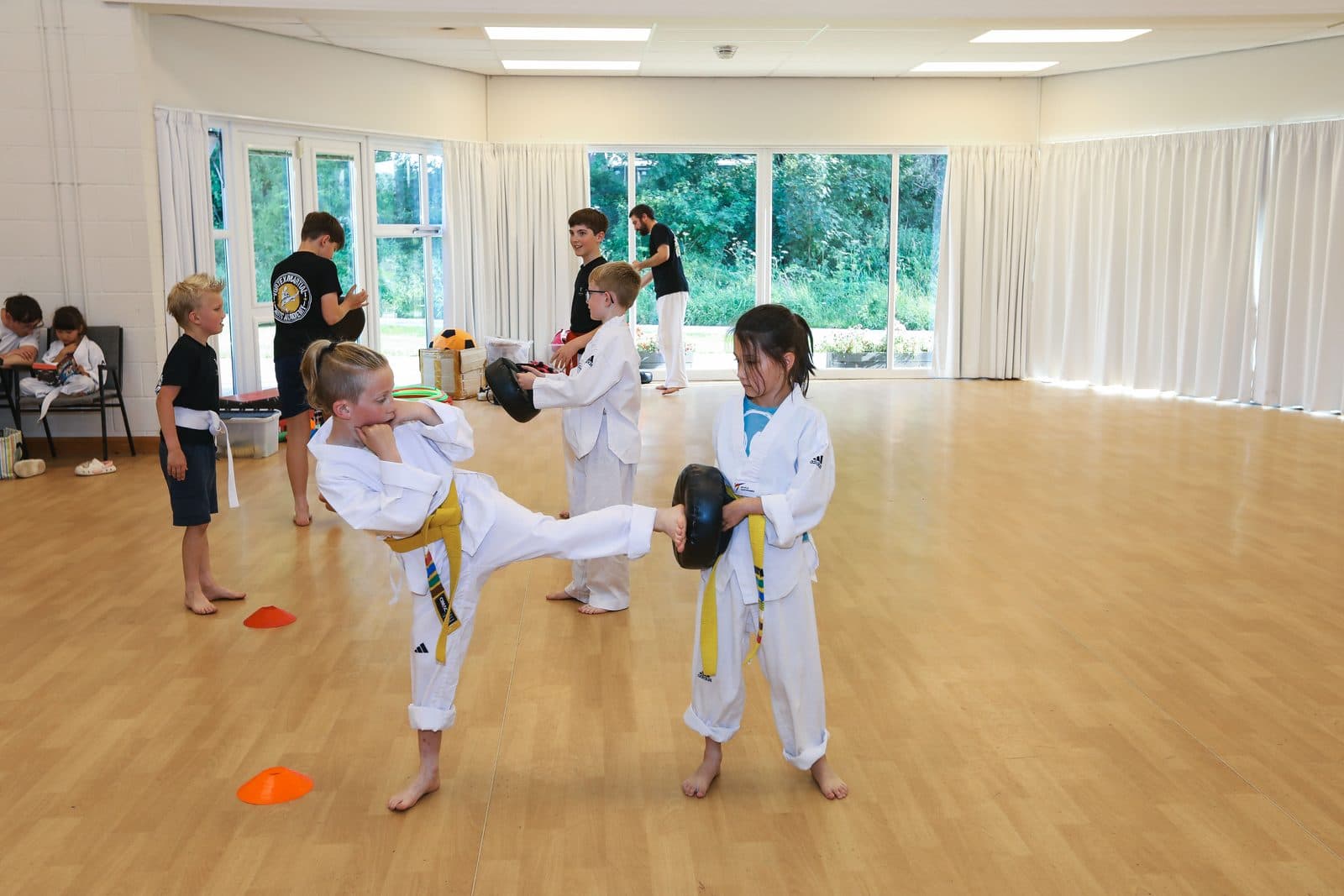 Taekwondo students aged 8 and above practising kicks and techniques at Vortex Martial Arts Academy