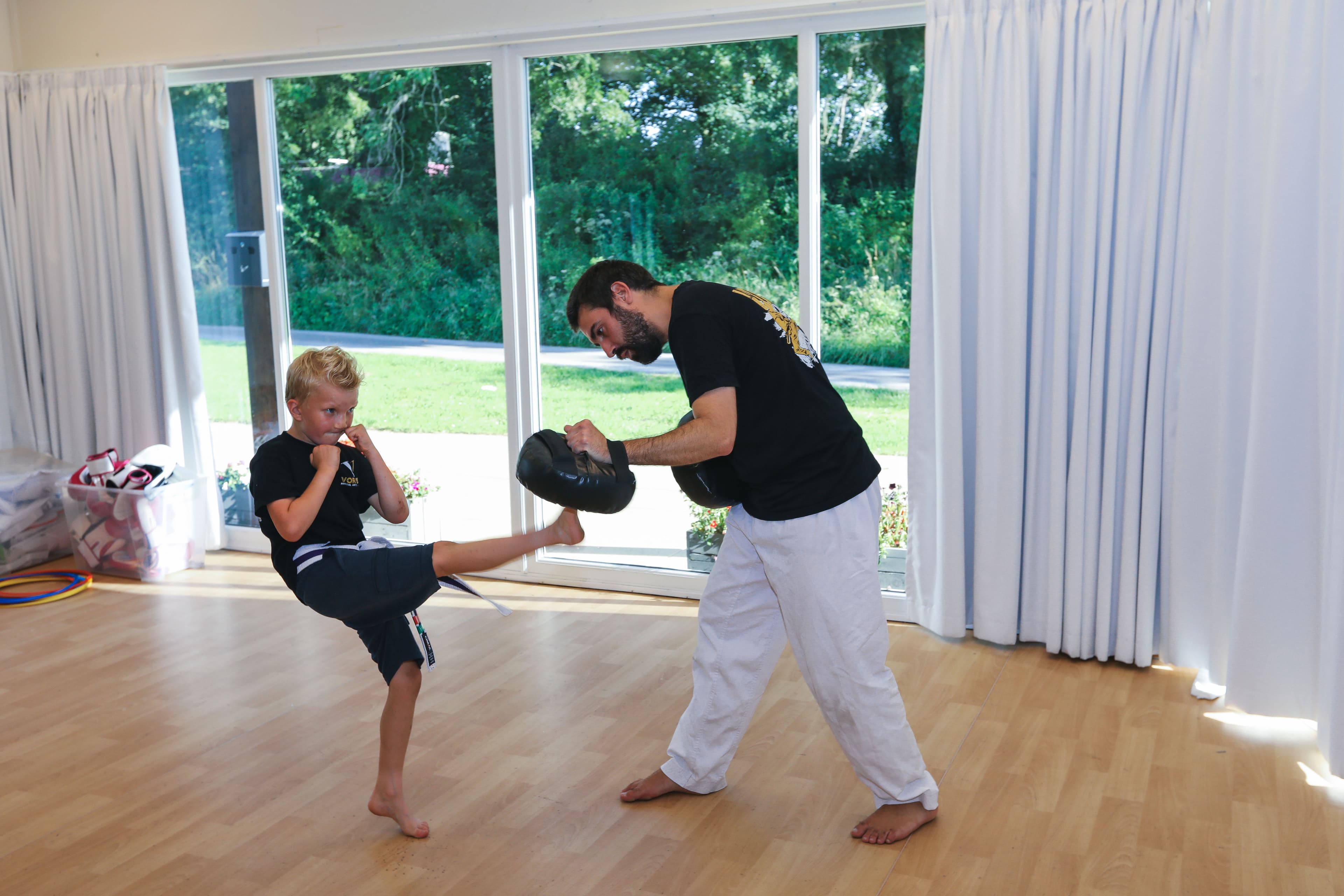 Children celebrating at the end of a Dragons class at Vortex Martial Arts Academy