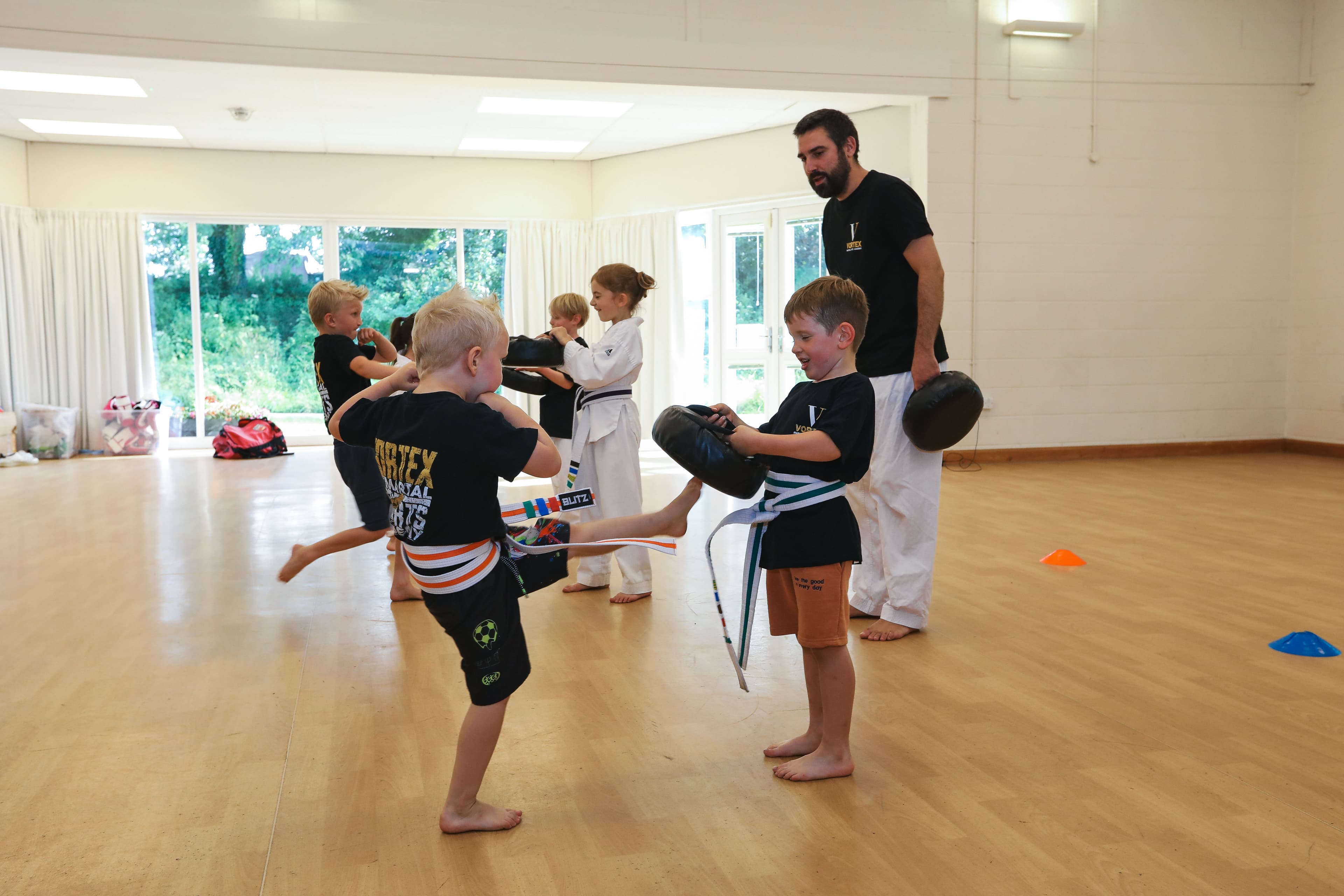 Children doing pad work in a Dragons class at Vortex Martial Arts Academy