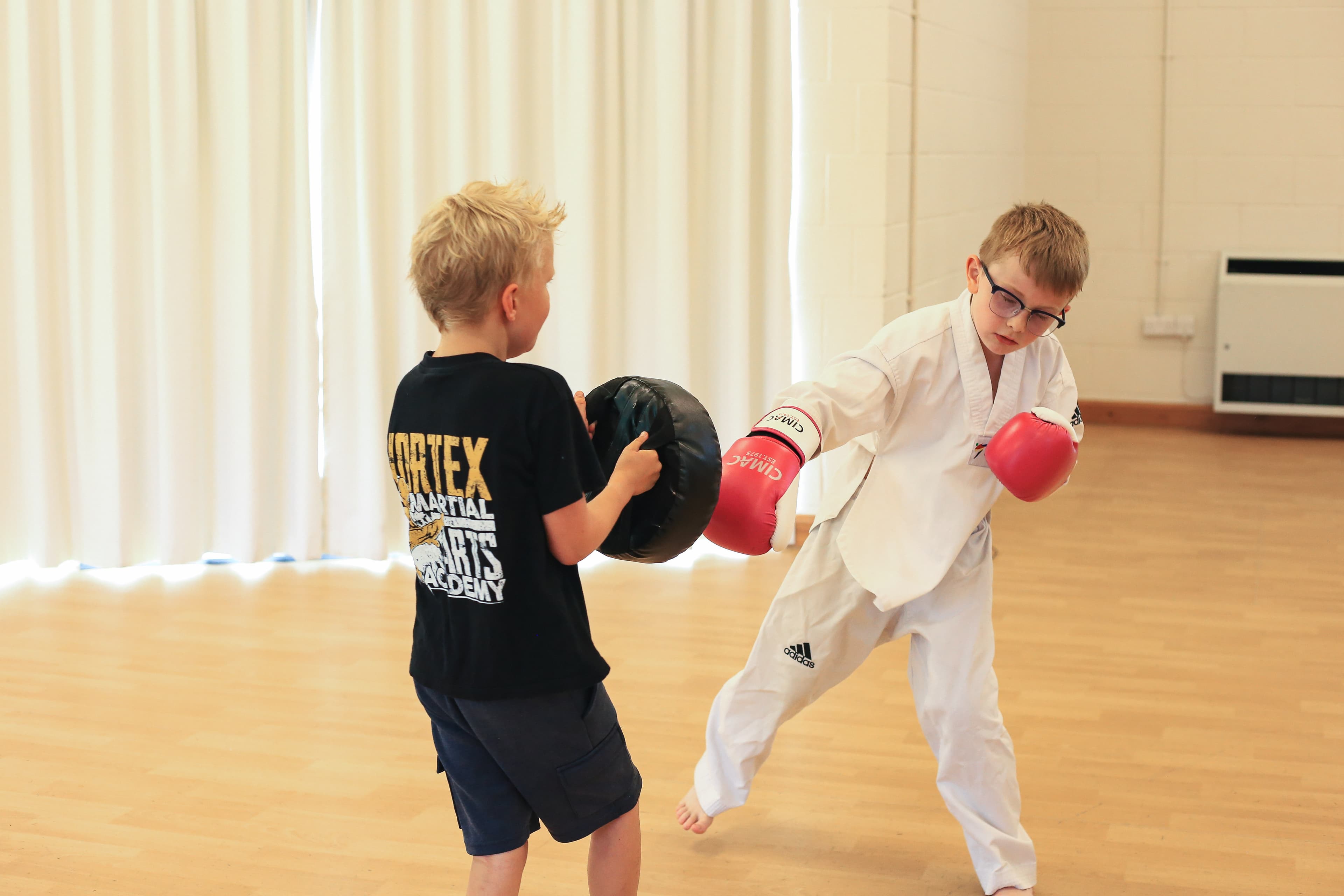 Kids in gloves during a Kickboxing class at Vortex Martial Arts Academy in Lancaster
