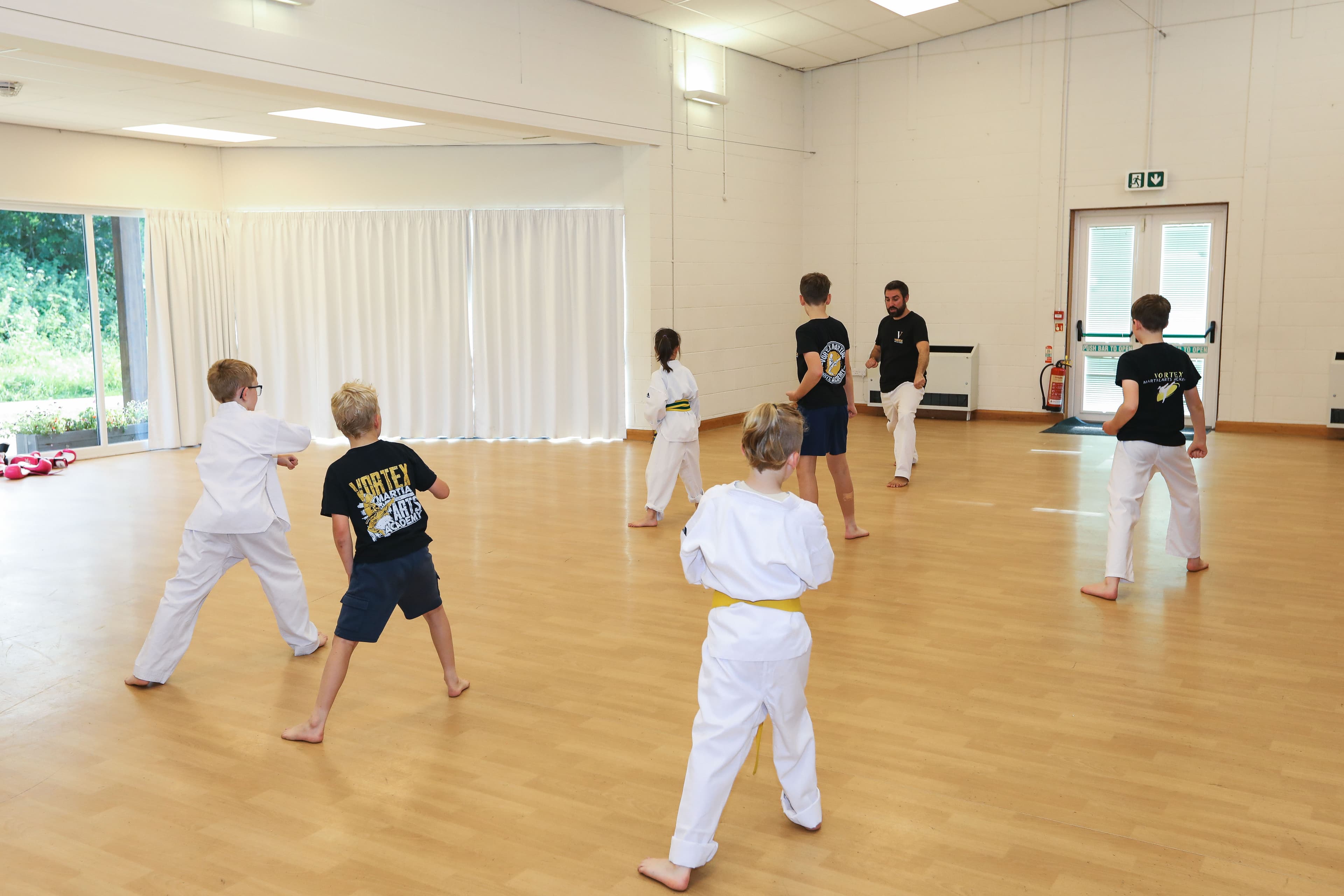 A wide shot of the Vortex Martial Arts Academy class training together