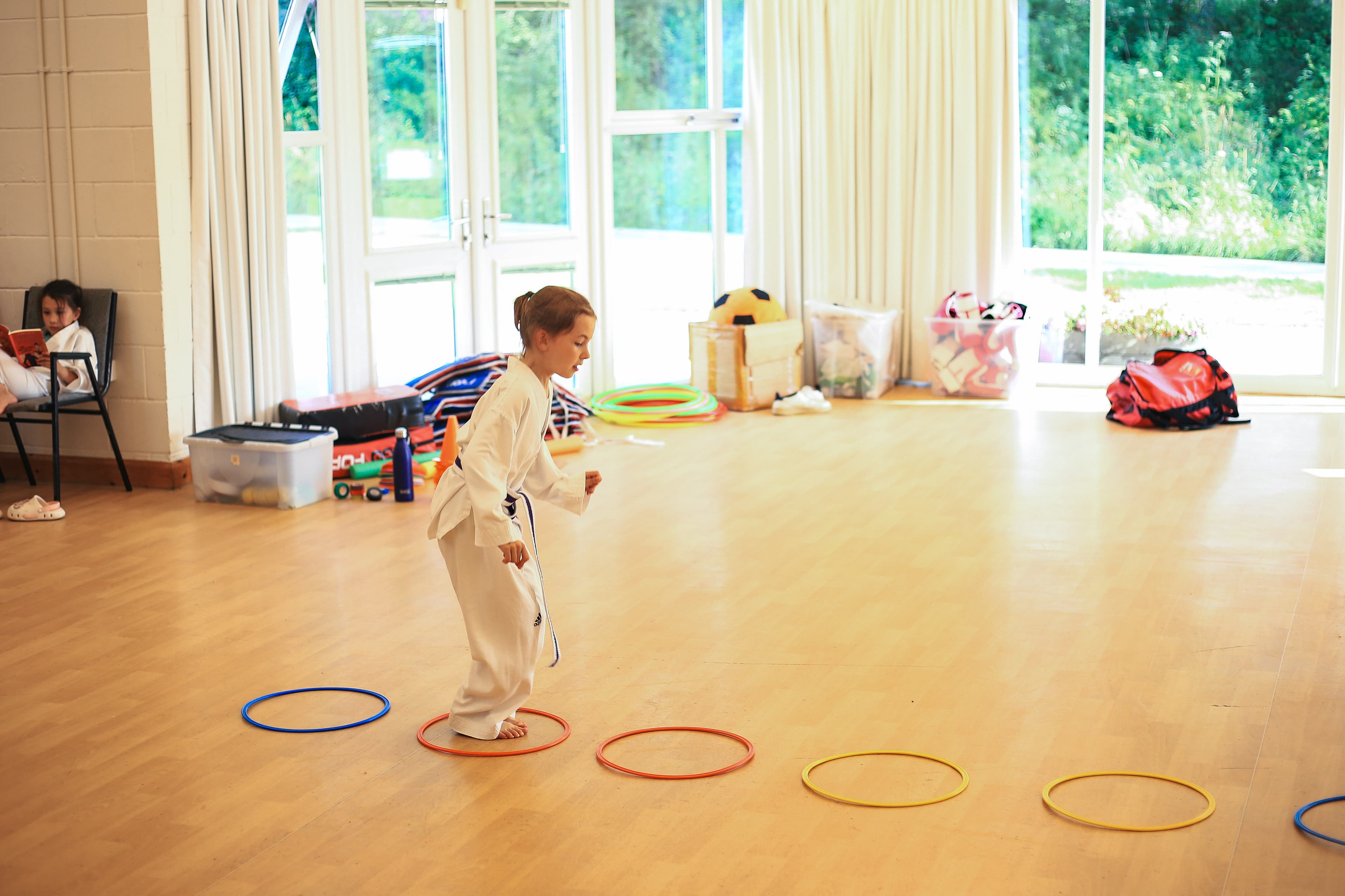 Students working through agility hoops at the start of class at Vortex Martial Arts Academy