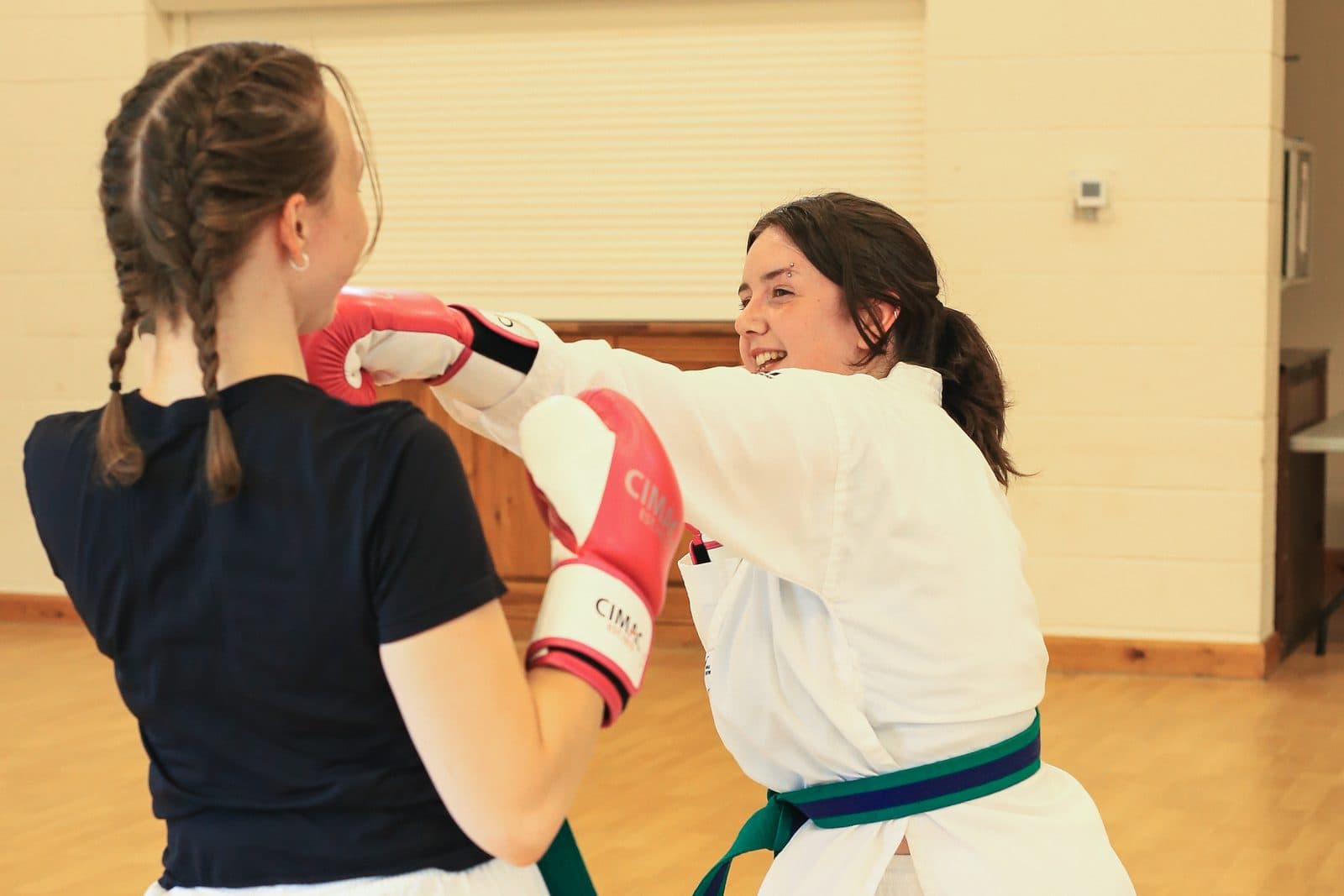 A child beaming with confidence after completing a martial arts drill at Vortex Martial Arts Academy